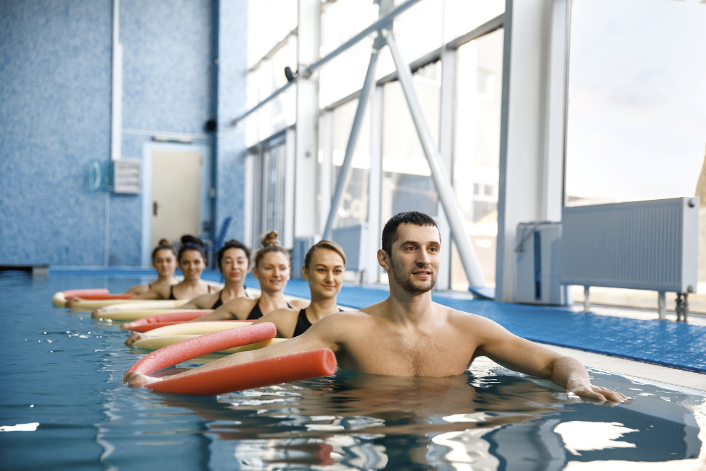 male-instructor-and-female-swimmers-group-aqua-aerobics-training-in-the-pool-man-and-women-in-the-water-sport-swimming-fitness-workout.jpg
