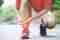 runner-touching-painful-twisted-or-broken-ankle-athlete-runner-training-accident-sport-running-ankle-sprained-sprain-cause-injury-knee-and-pain-with-leg-bones-focus-red-legs-on-to-show-pain.jpg